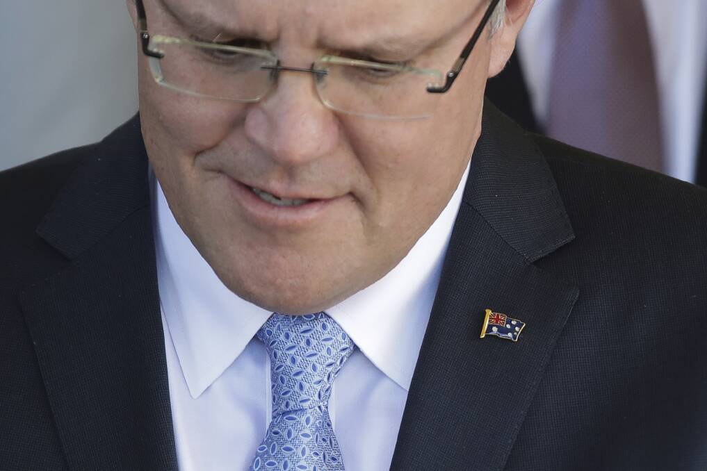 Prime Minister Scott Morrison gave all of his ministers an Australian flag lapel pin. Photo: Alex Ellinghausen