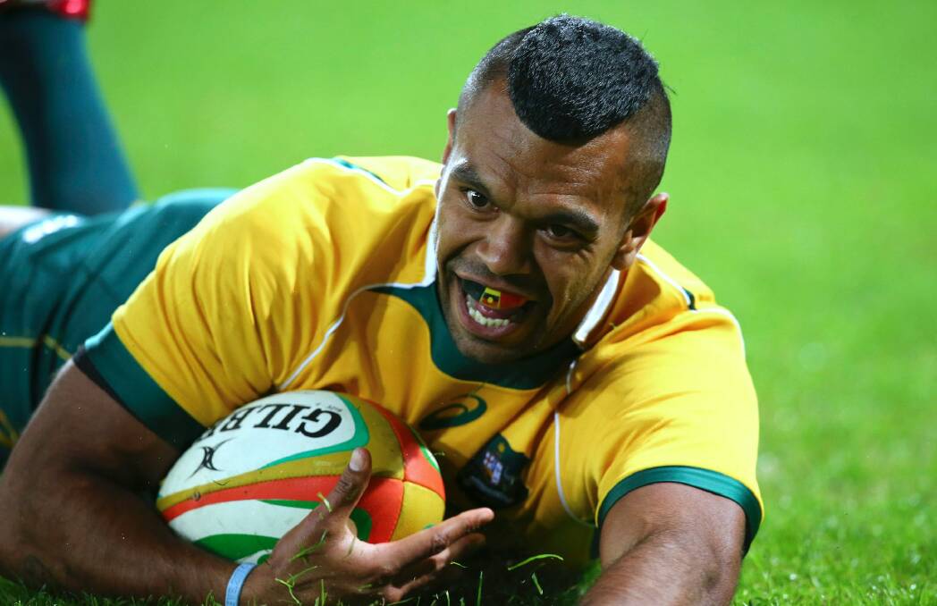 Kurtley Beale slides in for a try for Australia during a rugby test match against France in Brisbane.  Photo: AP