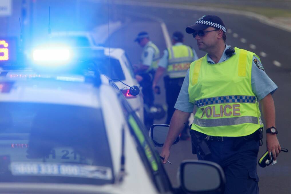 Motorists in NSW now have to slow to 40km/h when passing emergency vehicles flashing their blue and red lights. Photo: Greg Totman