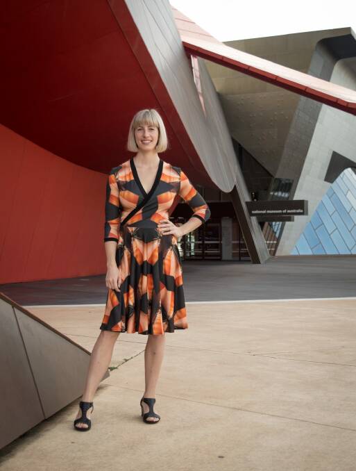 Yumi Morrissey from Zilpah Tart wearing a dress from her new collection, with a print featuring the National Museum of Australia. Photo: Holly Williams