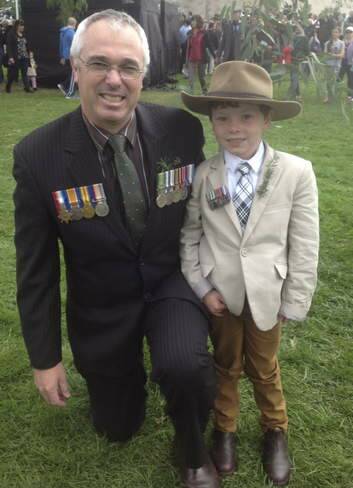 Major Andrew Martin, of Palmerston, with son Henry, 5, who marched with the East Timor contingent. Photo: Megan Doherty