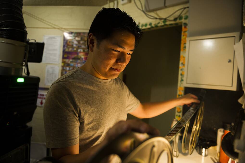 ANU film group president Adrian Ma looking at some of the old film. Photo: Dion Georgopoulos