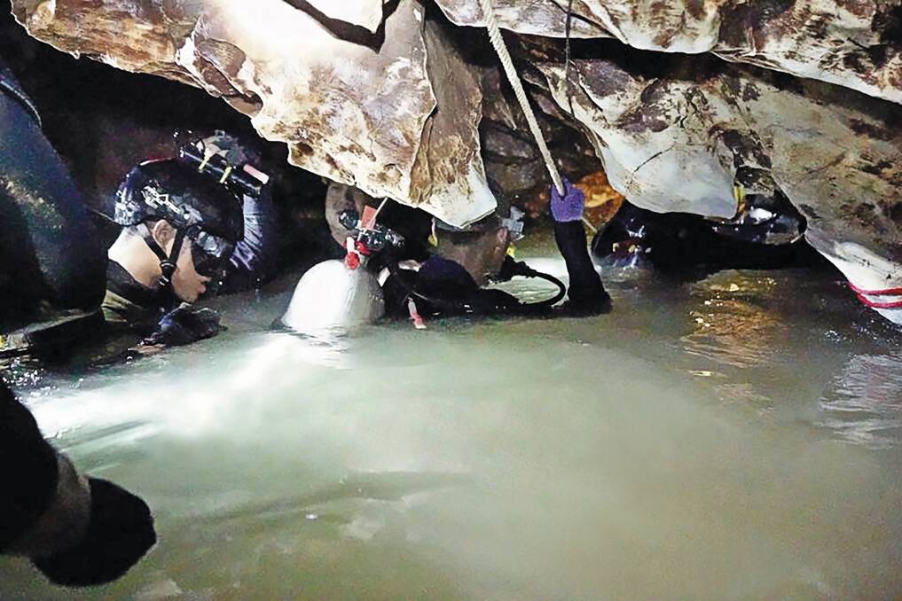 Ahead of the daring rescue, a team of divers brings supplies
and food into the cave for the boys and their coach. Photo: AAP