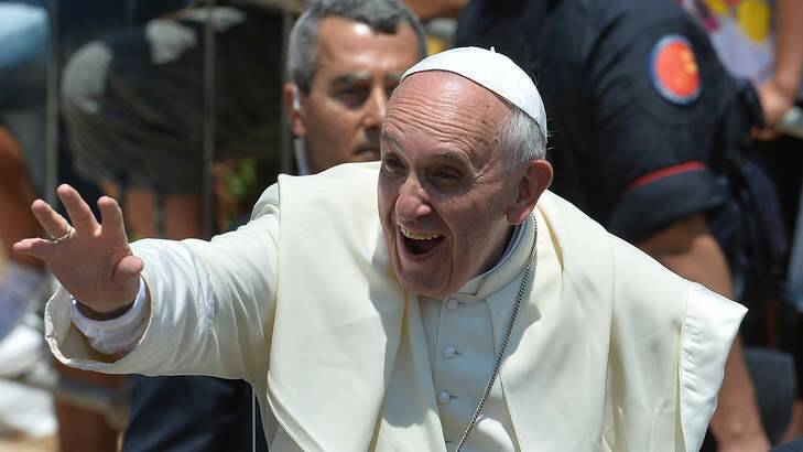 Pope Francis waves to the faithful after  laying a wreath on the sea in memory of those who have lost their lives in the crossing to Lampedusa from Africa. Photo: Getty Images