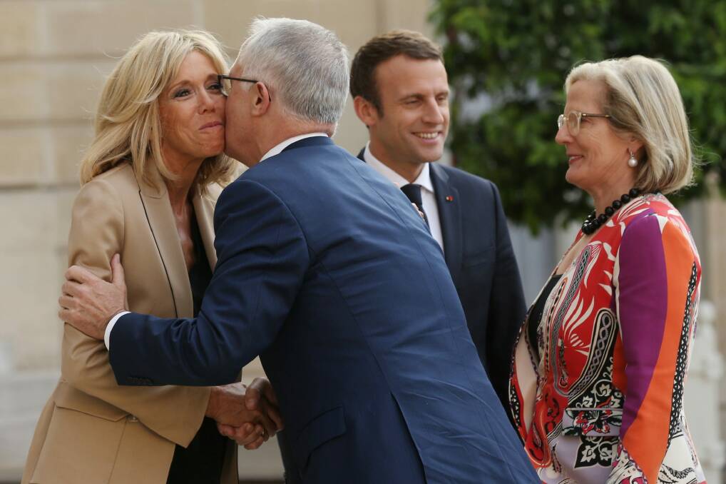 Malcolm Turnbull kisses Brigitte Macron, wife of French President Emmanuel Macron on arrival at the Palace. Photo: Andrew Meares