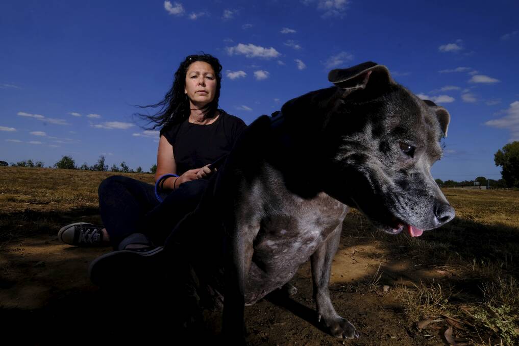 Lianne, seen here with her dog in Wyndham Vale, is taking Melbourne Uni to court over gender discrimination. Photo: Luis Ascui