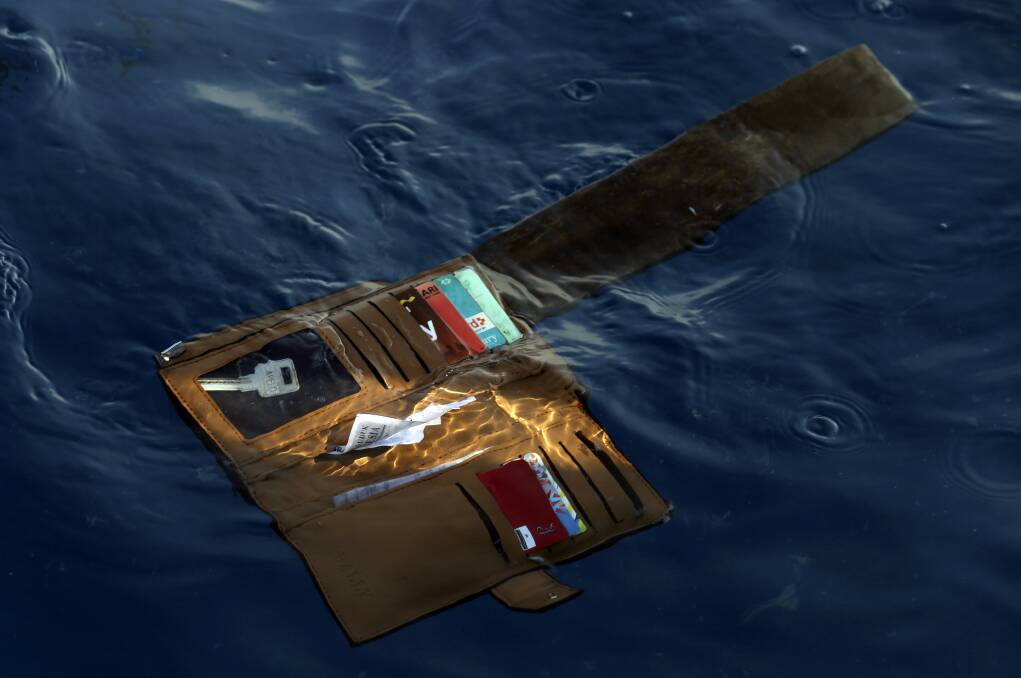 A wallet belonging to a victim of the Lion Air crash floats in the waters of Ujung Karawang, West Java. Photo: AP