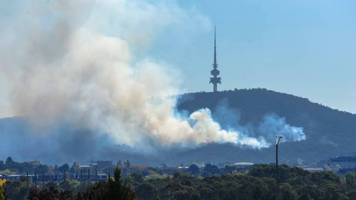 A controlled burn at Black Mountain is sending smoke above Canberra. Photo: Katherine Griffiths