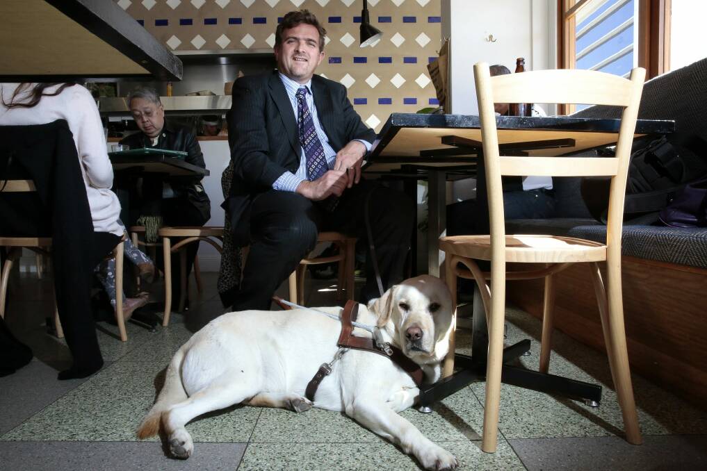 Stephen Fagg of Belconnen with his guide dog Samson at the Cupping Room. Photo: Jeffrey Chan