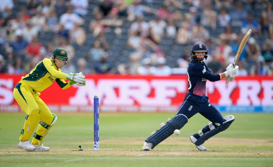 Cover drive: England's Danielle Wyatt hits out in front of Australian wicketkeeper Alyssa Healy. Photo: Stu Forster