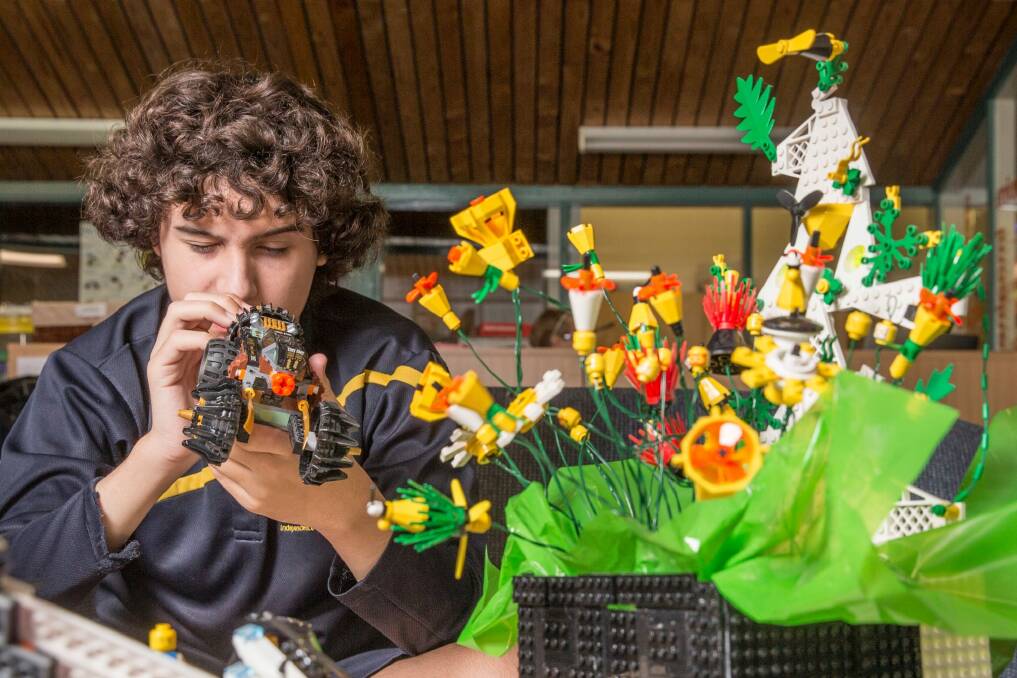 Year 10 Woden school student Jack Froggatt, 15, plays with some Lego in memory of student Mark Roberts who died last year due to complications from muscular dystrophy. Photo: Matt Bedford