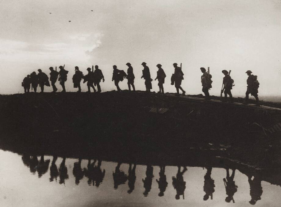 October 5, 1917: Supporting troops of the 1st Australian Division walking on a duckboard track near Hooge, in the Ypres Sector. Photo: Frank Hurley