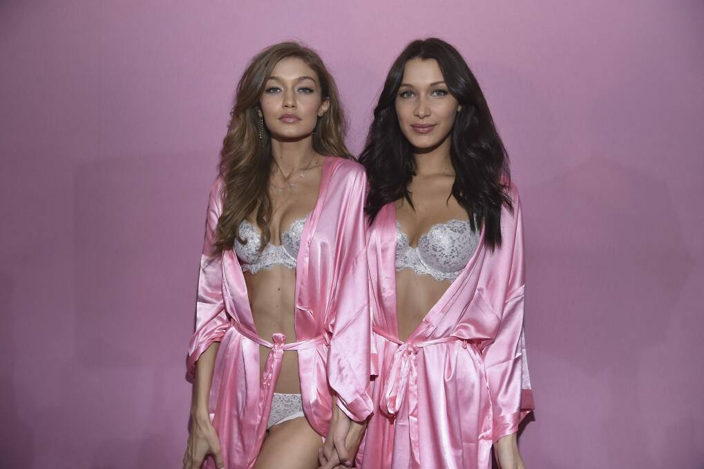 Sisters Gigi and Bella Hadid pose backstage prior to the 2016 Victoria's Secret Fashion Show in Paris. Photo: Pascal Le Segretain