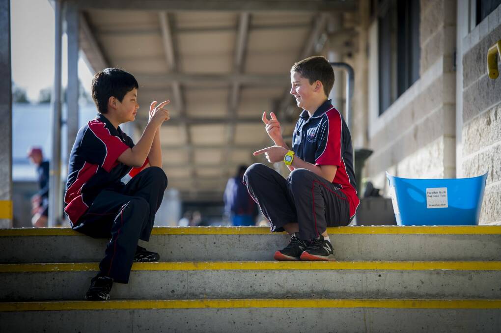 Amaroo School student Ross Kelly (right), who learnt sign language to talk with deaf friend Isam Gurung. Photo: Karleen Minney