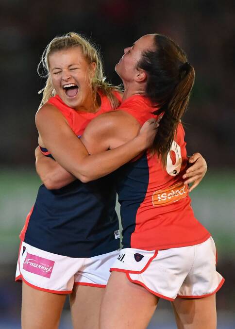 Sarah Jolly and Daisy Pearce celebrate a goal. Photo: Quinn Rooney