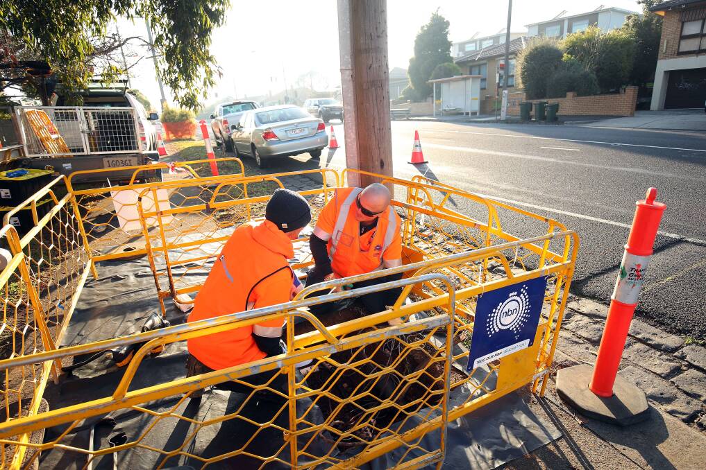 NBN workers lay the cable as the roll-out nears its final stage. Photo: NBN
