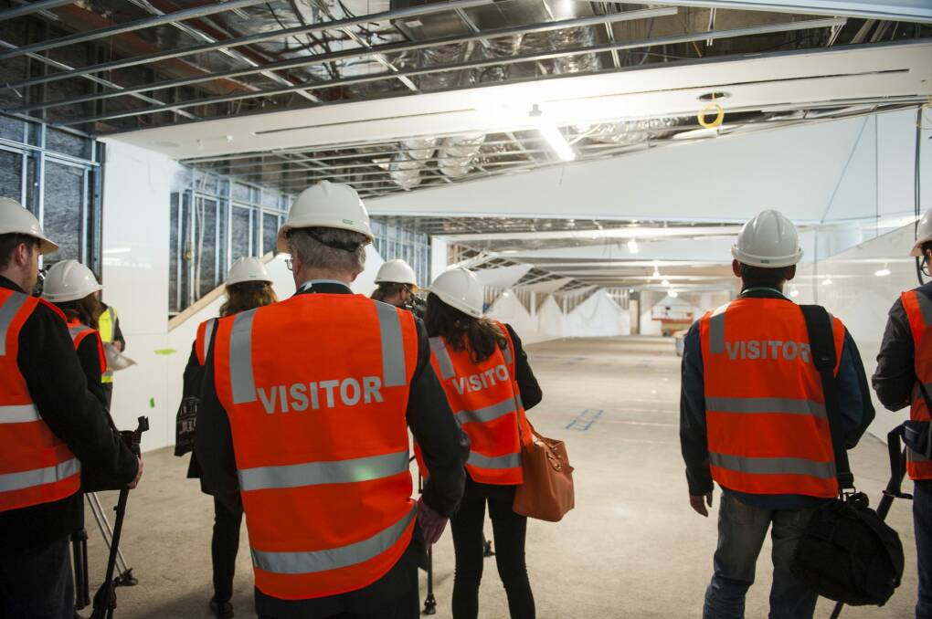 Stephen Byron escorts media on a guided tour of the construction site of the $18 million fitout for the new international terminal. Photo: Elesa Kurtz