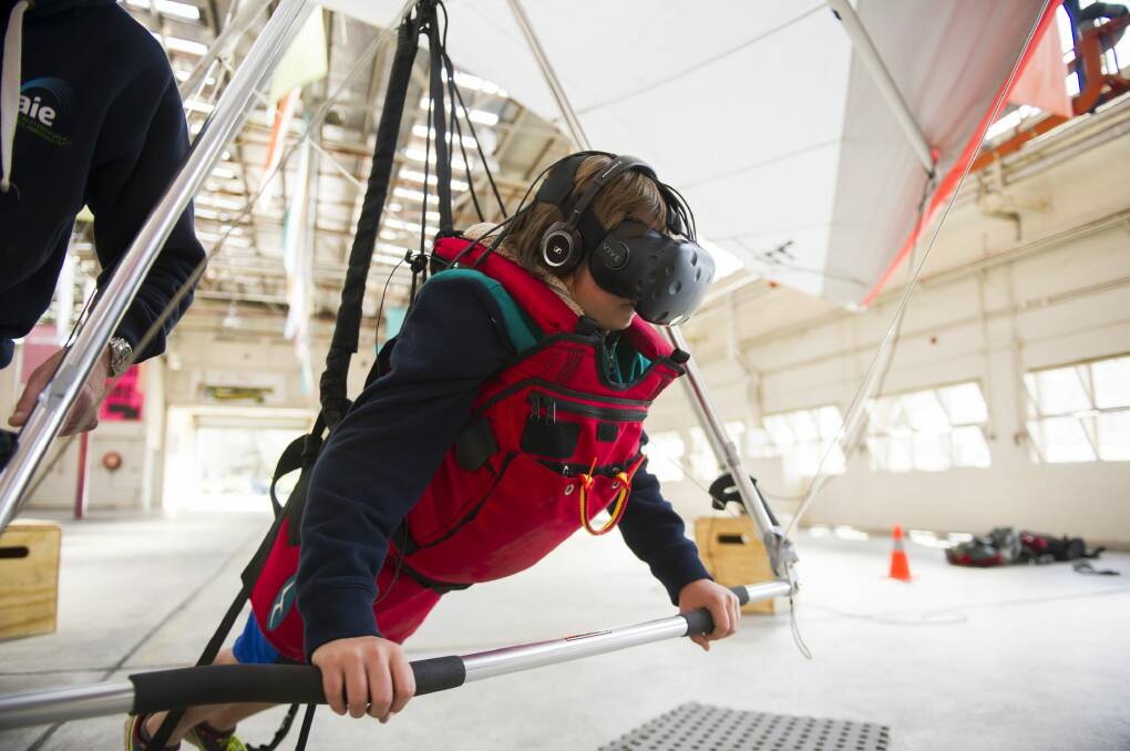 Oskar Rug, 10, using the hang gliding simulator. Photo: Rohan Thomson