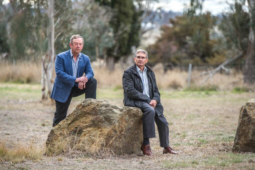 Former Flynn neighbours Robin Eckermann and Peter Toscan are concerned about the impact of a former sheep dip site near their former homes in Fraser. The men, who have both had cancer, are pictured at the end of their street. Photo: Karleen Minney