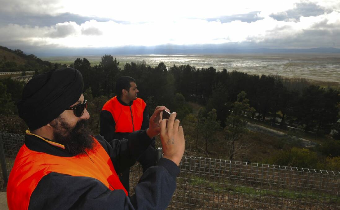 Truck driver Hardaypal Singh, left, and friend Reghav Sherme stop to take a photo at Lake George. Photo: Graham Tidy