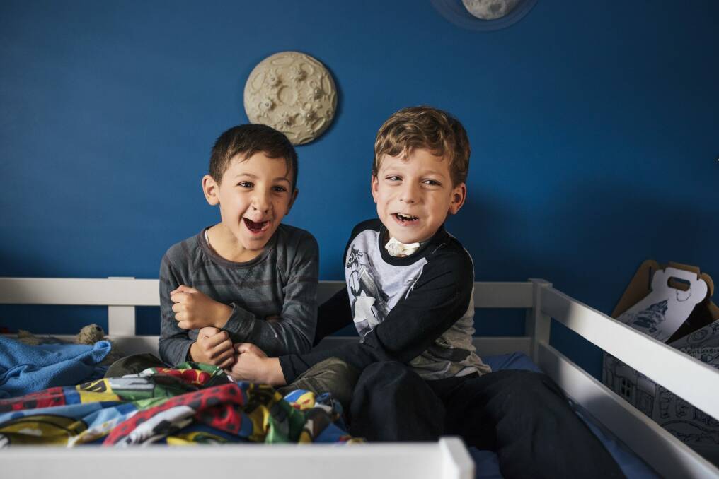 Seven-year-old Dominic McFadden, right, who lives with autism and a tracheostomy, at home with his brother Sebastian, 8.  Photo: Rohan Thomson