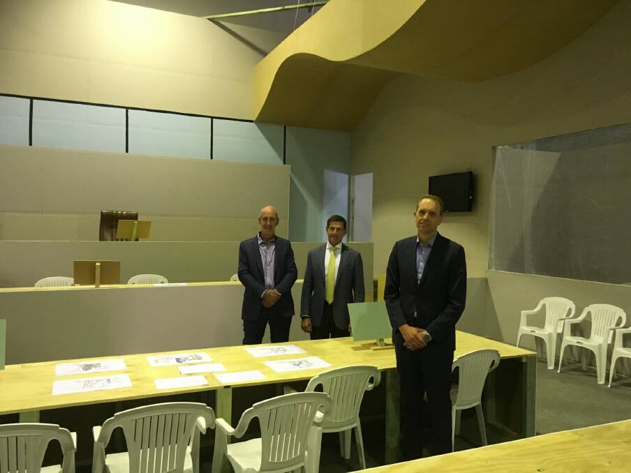 From left, architect Cameron Lyon, Juris Partnership general manager David Lovell, and Attorney-General Simon Corbell who toured the mock courtroom on Tuesday. Photo: Supplied