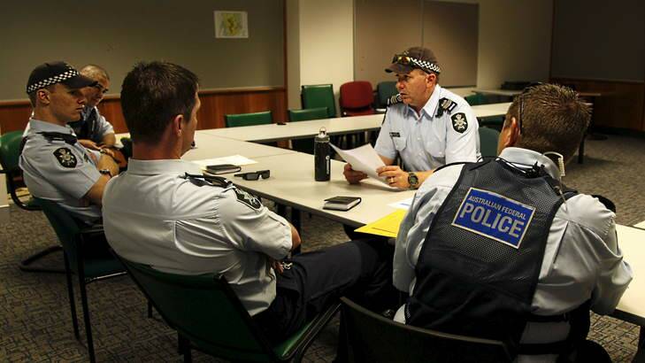 Sergeant Andrew Mitchell briefs his team before they go on patrol. Photo: ACT Policing
