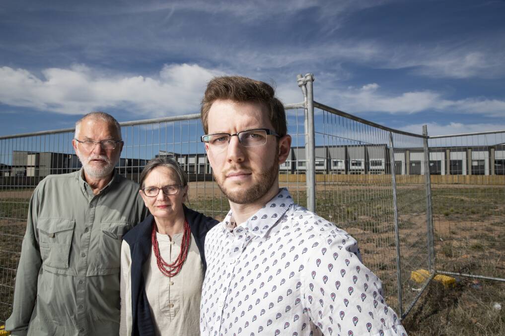 Local residents John and Alison Hutchison, and Ryan Hemsley standing in front of the site where 212 units are proposed. They are angered by a development proposal in Coombs that's larger than what was intended for the site when it was sold in February this year.  Photo: Sitthixay Ditthavong