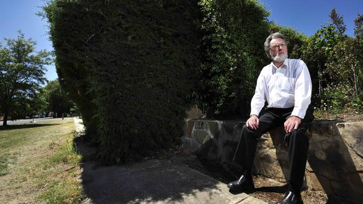 Leon Arundell of the North Canberra Community Council had previously been forced to walk on the grass due to the overgrown hedge. Photo: Jay Cronan
