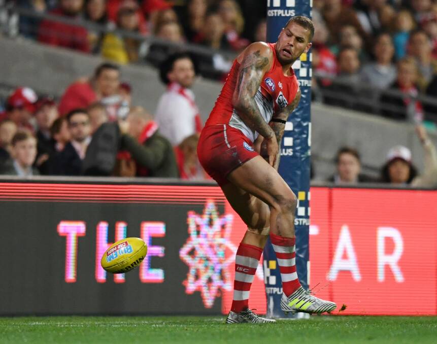 Luck favours the brilliant: Lance Franklin looks around after the ball bounces off his foot for a goal. Photo: AAP