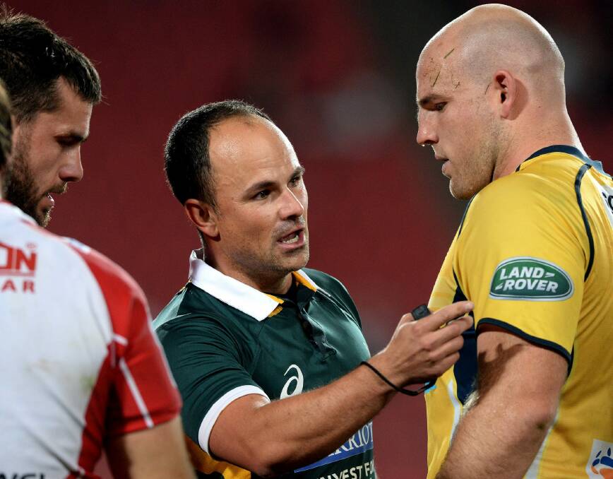 Laying down the law: Referee Jaco Peyper talks to Brumbies co-captain Stephen Moore. Photo: Gallo Images