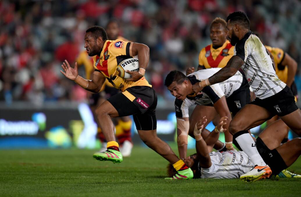 Breakthrough: Justin Olam in full flight for PNG in their upset win over Fiji. Photo: AAP