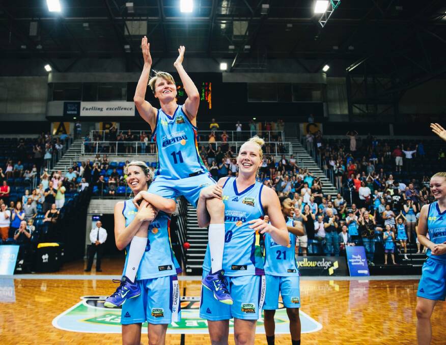 On a high: Jess Bibby is chaired off after her last WNBL game but now has her sights on Australian football. Photo: Rohan Thomson