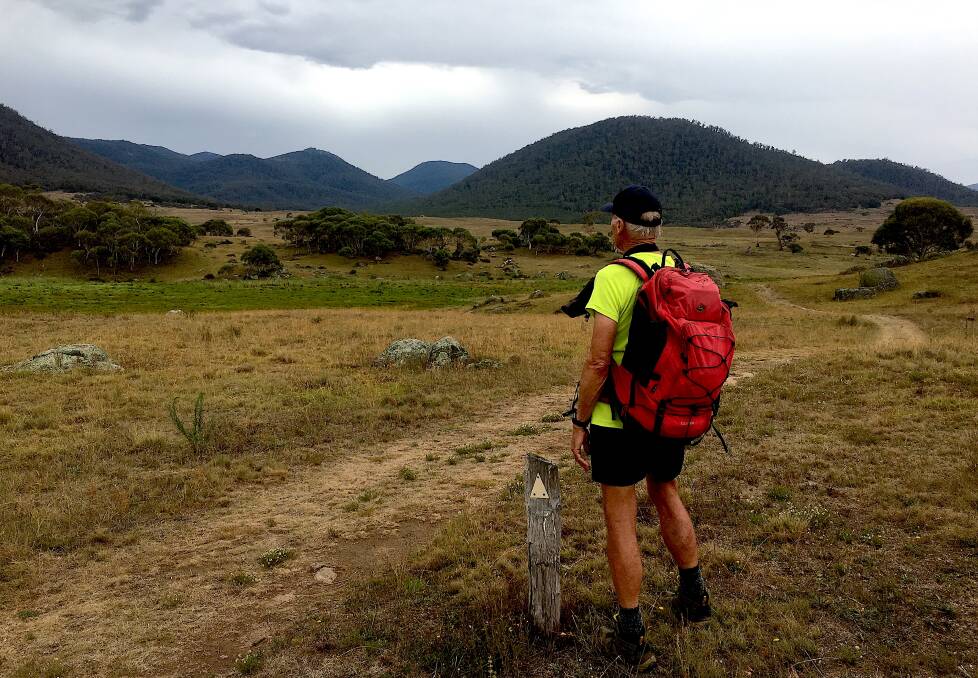 John Evans looks towards the distant horizon and his three favourite peaks in Namadgi National Park – Mt Kelly, Mt Burbidge and Mt Namadgi. Photo: Tim the Yowie Man
