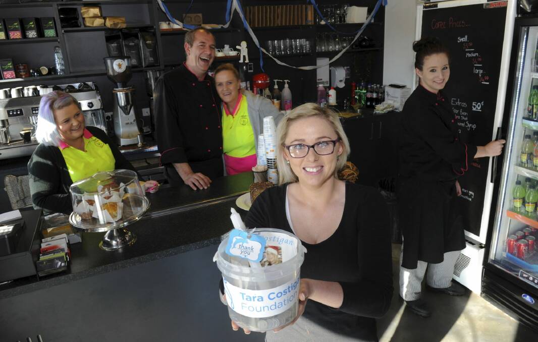 Brooke Morris, front, in her family cafe, Little
Billy's Cafe at Weston Creek, which has raised $7000 for the
Tara Costigan Foundation. Other cafe staff, from left, are Rebecca Morris, Bill Lyras,
Karen Morris and Katelyn Cross-Hicks. Photo: Graham Tidy