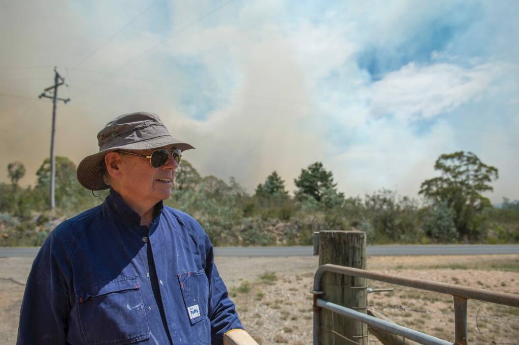 Ken Doolan prepared to fight the on coming fire on Friday afternoon. Photo: Jay Cronan