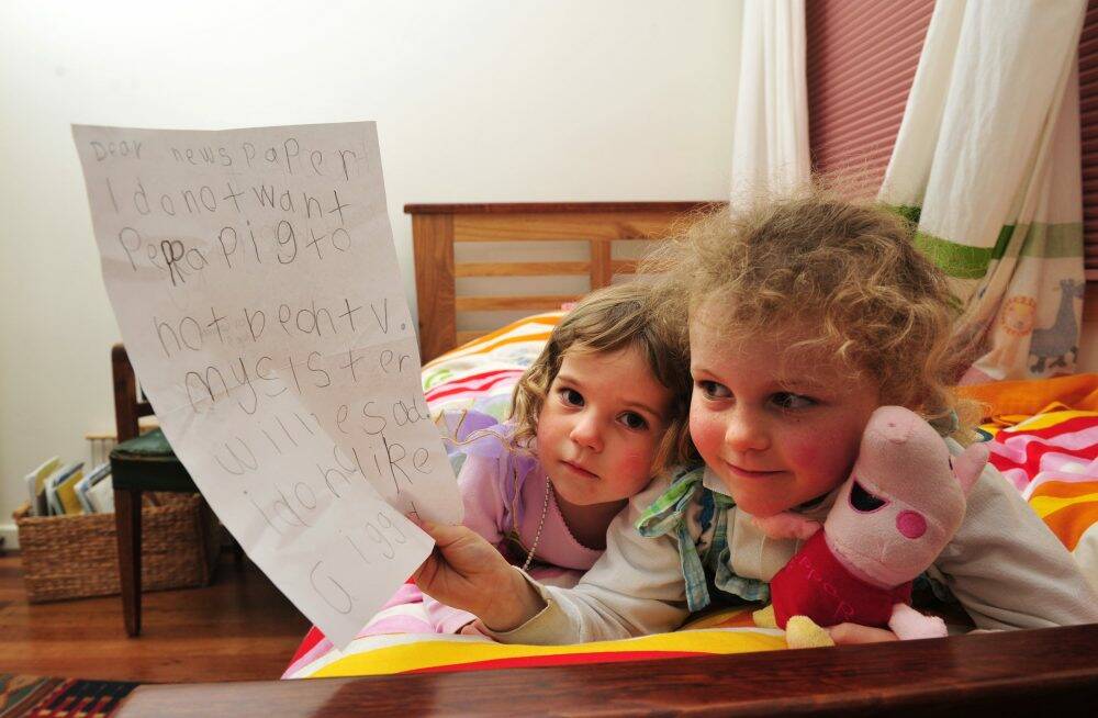  Peppa Pig fan, Tess Coventry, 5 with the letter that she wrote to the paper hoping that Peppa Pig wouldn't be taken from her tv because her sister India, 2 1/2 would be sad.  Photo: Melissa Adams