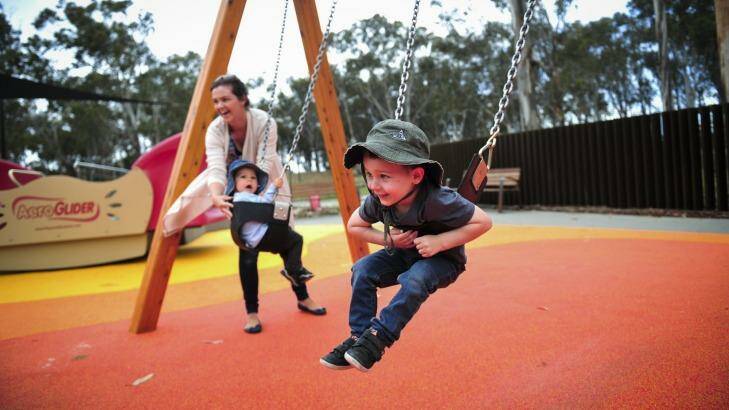 Child's play: Kathryn Smith, of Bruce, enjoys the Boundless Canberra playground with children, from left, Henry, 1, and Owen, 2. Photo: Melissa Adams