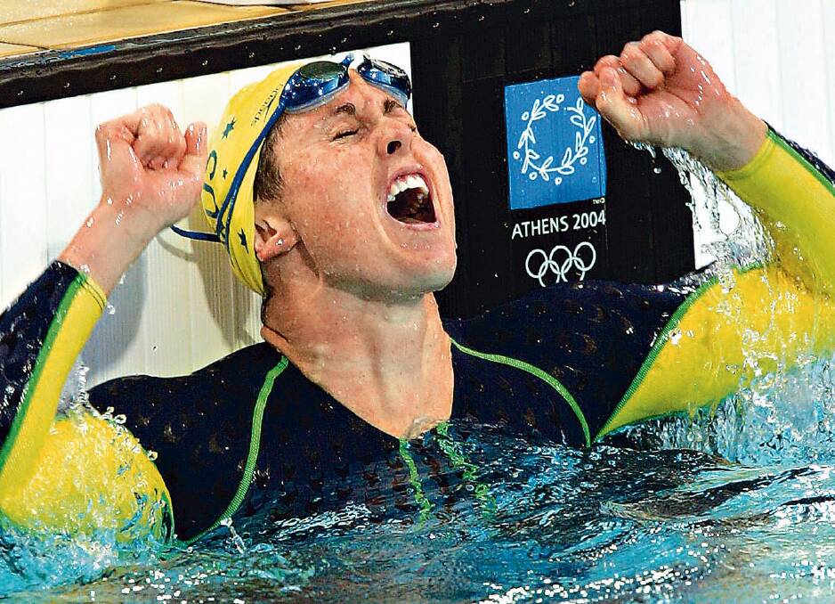 Petria Thomas celebrates after winning a gold medal in the 100-meter butterfly at Athens Olympic Games. Photo: AP