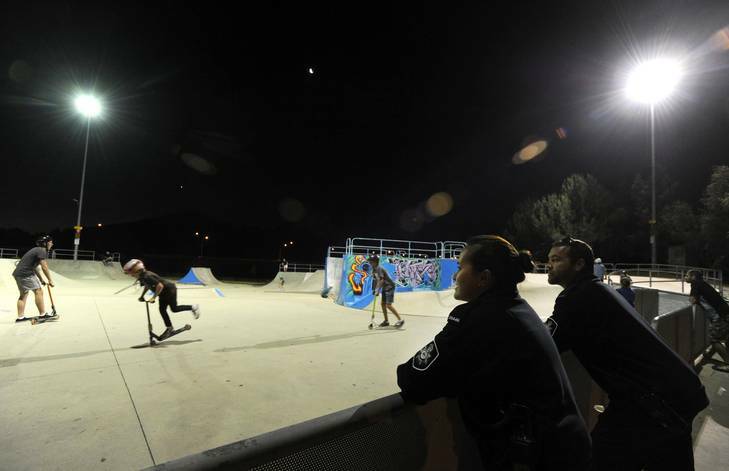 Police from the Tuggeranong Station, Constables Justin Bateman and Rachel Thomson, keep a watch on young boys at the local skate park. Photo: Graham Tidy
