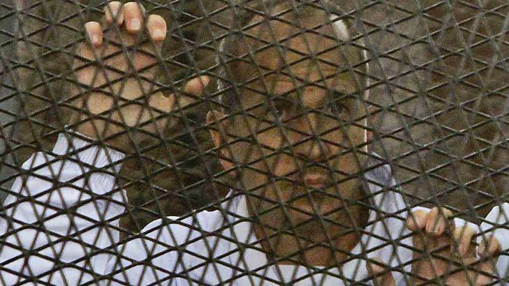 Al-Jazeera journalist Peter Greste inside an Egyptian courtroom's defendants' cage earlier this month. Photo: AP