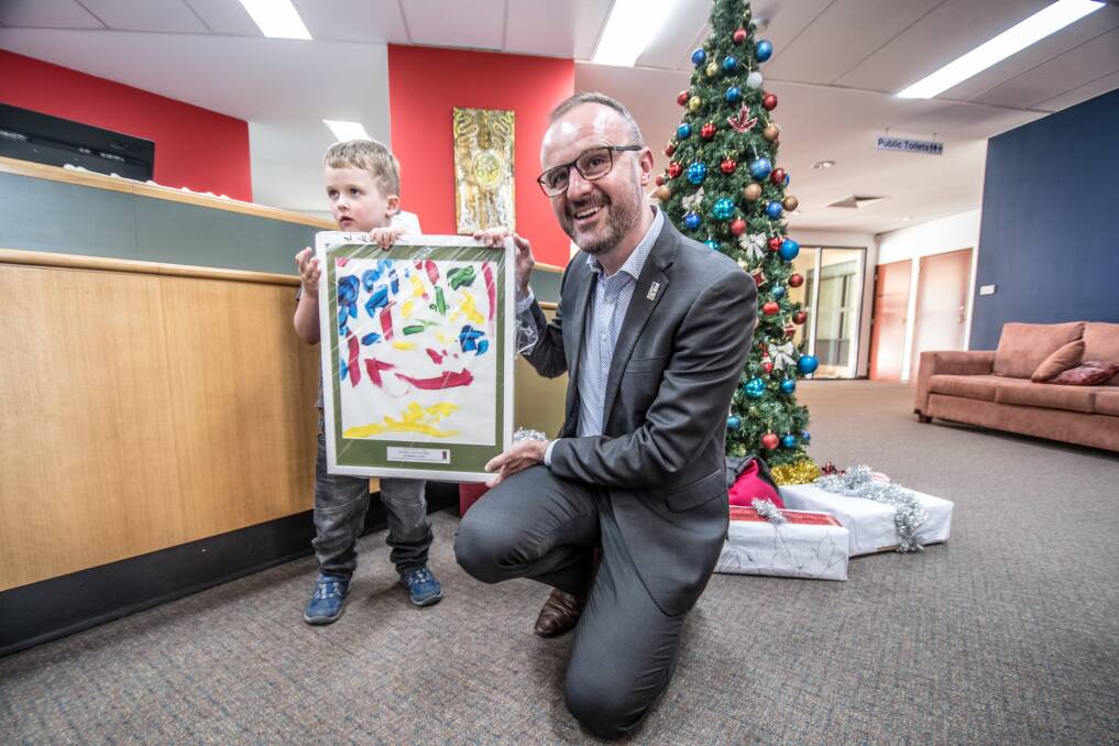 Five-year-old Rowan Blackmore, of Kambah, had the honour of presenting his framed painting to Chief Minister Andrew Barr at the Smith Family Christmas Appeal launch on Friday. Photo: Karleen Minney