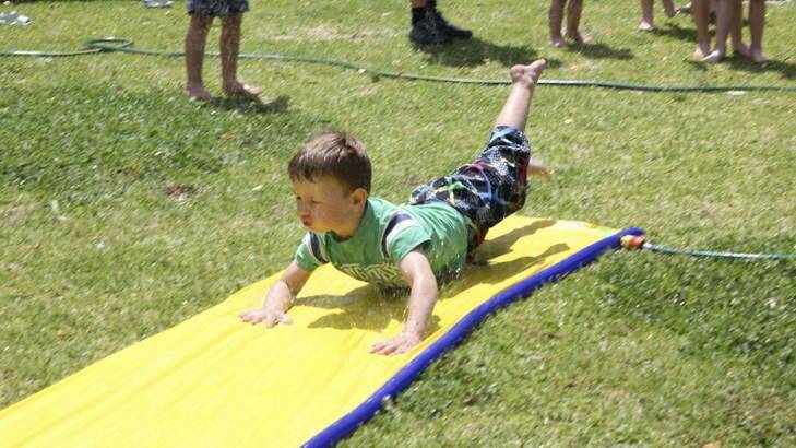 Entrant into The Canberra Times' summer photo competition. Noah Smith enjoying the slip-n-slide at his 5th birthday party. Photo: Kate Porter-Smith