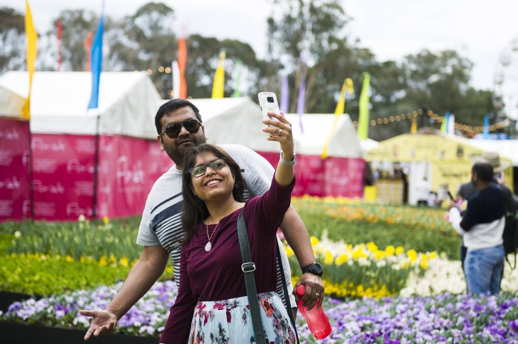 People come to take selfies in front of the flower beds at Floriade. Photo: Dion Georgopoulos