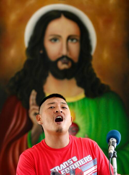 Andrew Chan singing praise during mass. Photo: Danny Arcadia
