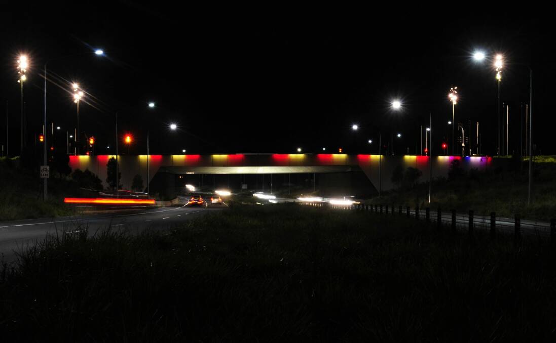 The Kings Avenue bridge will be lit up in Belgium's national colours of red, black and yellow at night until next week. Photo: Melissa Adams