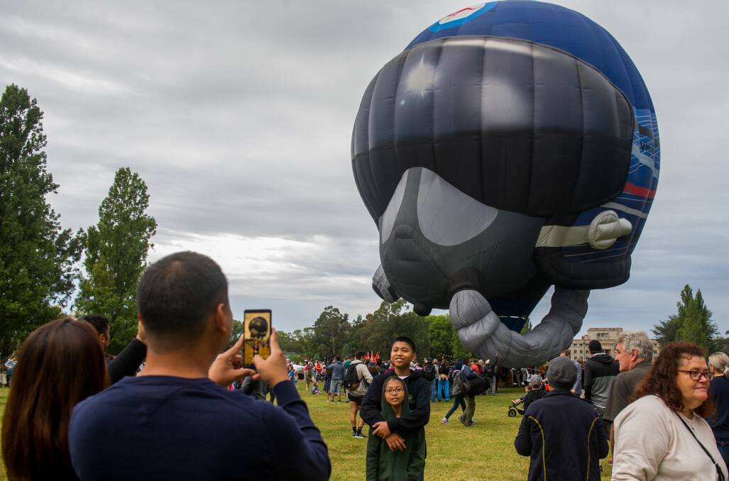 A Royal Australian Air Force hot air balloon shaped like a pilot's helmet. Photo: Elesa Kurtz