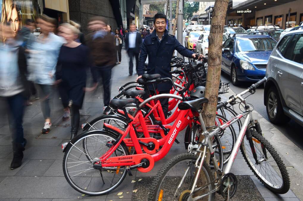 Reddy Go founder Donald Tang with dozens of bikes ready to hit the streets last July. Photo: Nick Moir