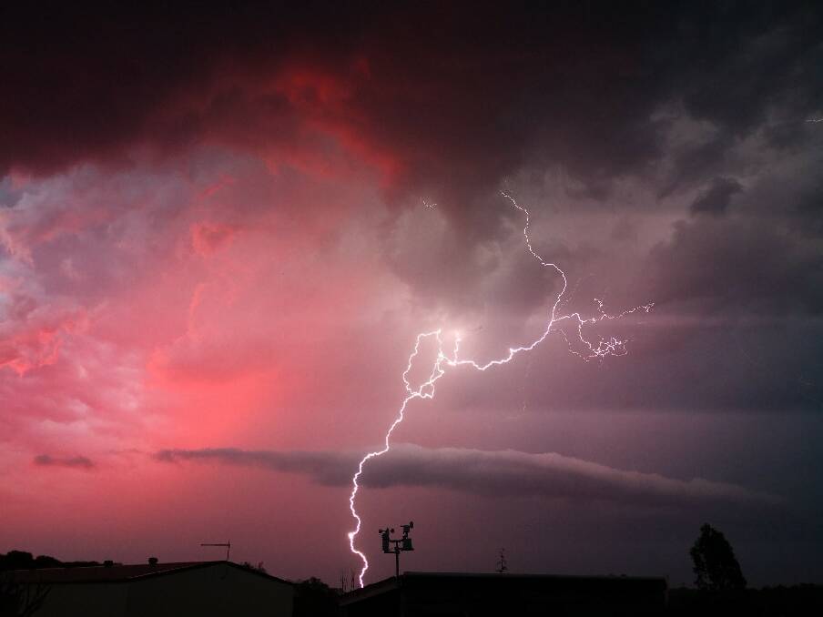 Lightning strikes with the backdrop of a red sky in the Ipswich suburb of Karalee on Wednesday night. Photo: Facebook - Belinda Turvey