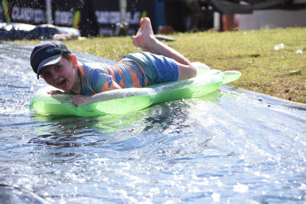 William cools down on a slip and slide at Lake Moondarra in Mount Isa, 120 kilometres west of Cloncurry. Photo: Lydia Lynch